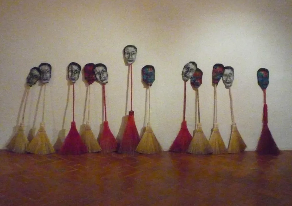<p>Cotidianamente | Instalacion, con caras, impresas en tela con linóleo, y escobas de diferntes tamaños | 2009</p>

